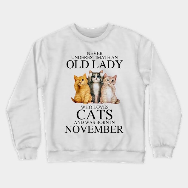 Never Underestimate An Old Lady Who Loves Cats November Crewneck Sweatshirt by louismcfarland